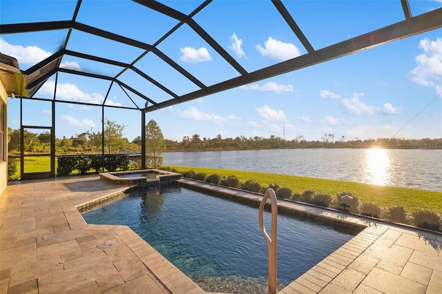 view of pool featuring glass enclosure, a water view, and a patio area