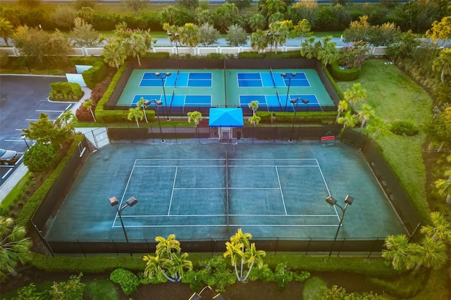 view of tennis court featuring fence