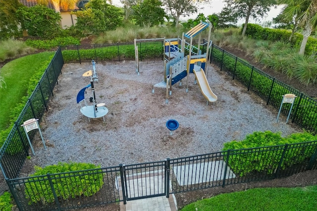 view of property's community featuring playground community and fence