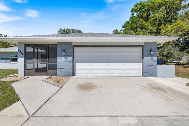 garage featuring concrete driveway