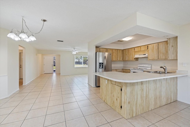 kitchen featuring white range with electric cooktop, light tile patterned flooring, stainless steel fridge with ice dispenser, light countertops, and under cabinet range hood