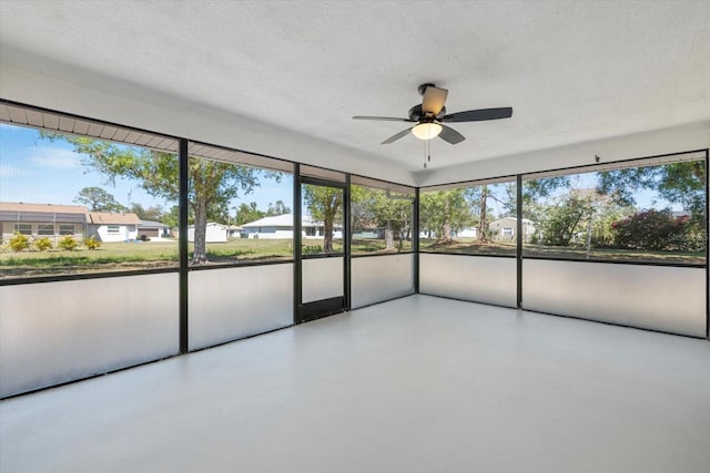 unfurnished sunroom with a healthy amount of sunlight and ceiling fan