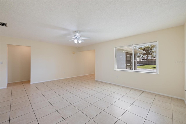 spare room with baseboards, a textured ceiling, and a ceiling fan