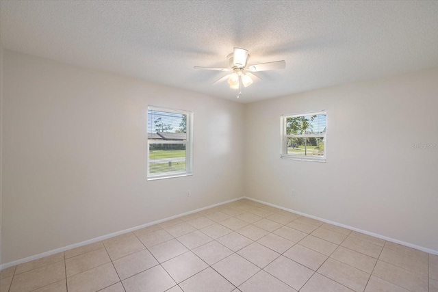 unfurnished room featuring a textured ceiling, baseboards, and ceiling fan