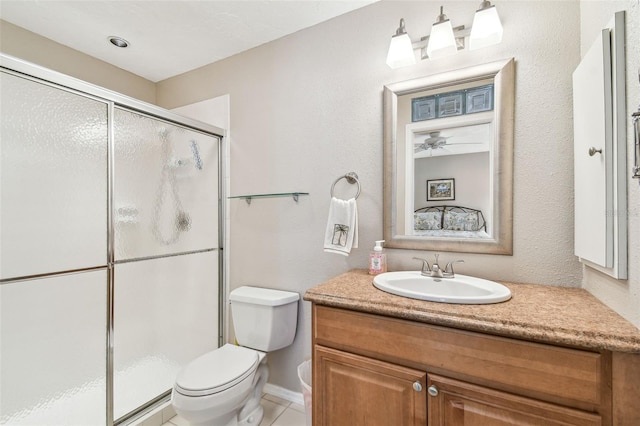 full bath featuring toilet, a stall shower, vanity, and tile patterned flooring