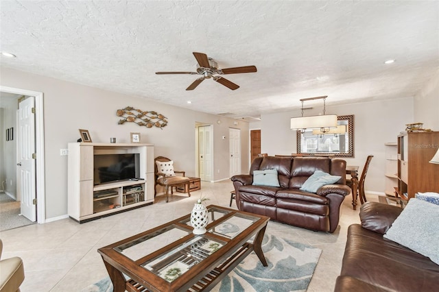 living room featuring baseboards, light tile patterned floors, recessed lighting, a textured ceiling, and a ceiling fan