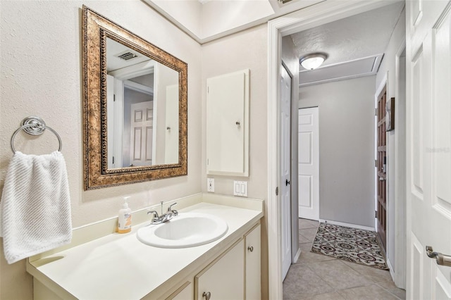 bathroom with tile patterned floors, visible vents, and vanity