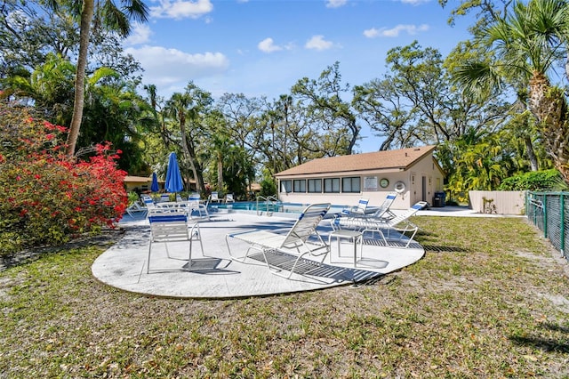 exterior space with a patio, fence, and a lawn