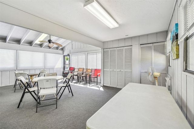 sunroom with ceiling fan and vaulted ceiling