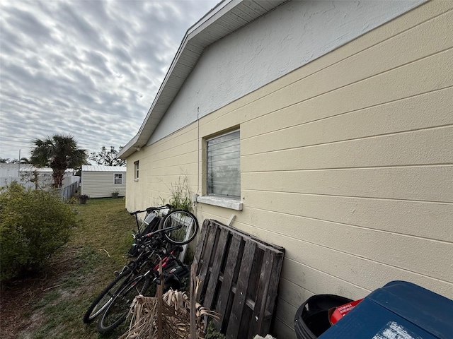 view of side of property featuring fence