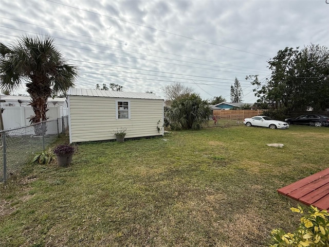 view of yard with an outbuilding and fence