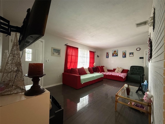 living room with baseboards and visible vents