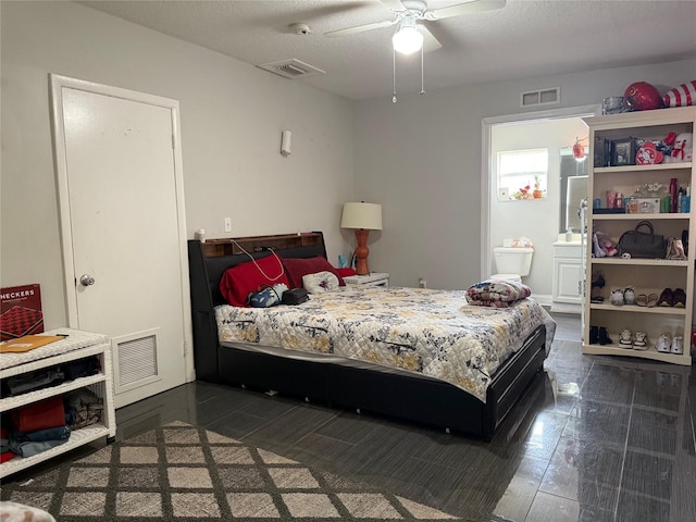 bedroom with visible vents, a textured ceiling, ensuite bath, and a ceiling fan