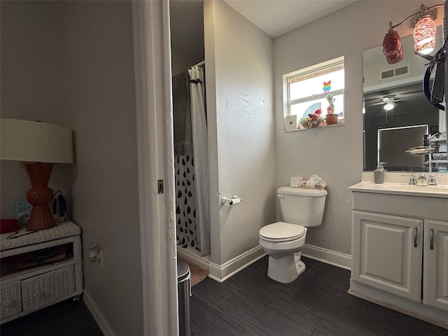 bathroom featuring visible vents, baseboards, toilet, a shower with curtain, and vanity