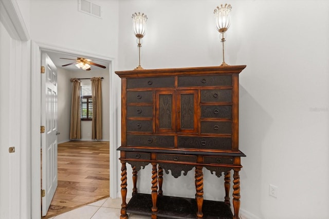 interior space with ceiling fan, visible vents, and wood finished floors