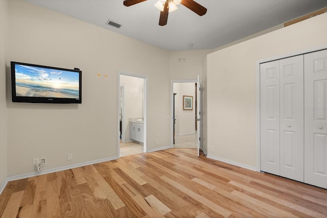 unfurnished bedroom featuring visible vents, ensuite bathroom, light wood-type flooring, and baseboards