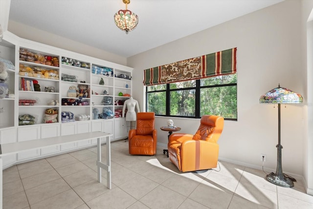 sitting room featuring tile patterned floors and baseboards