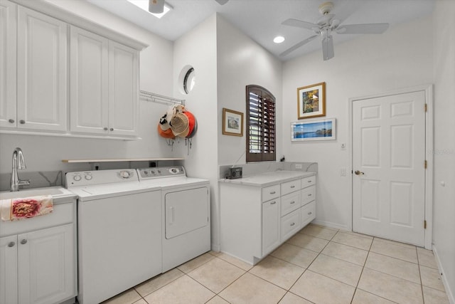 laundry area featuring washing machine and clothes dryer, light tile patterned flooring, cabinet space, a ceiling fan, and a sink