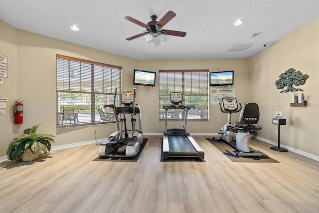 workout room featuring recessed lighting, wood finished floors, baseboards, and a textured ceiling