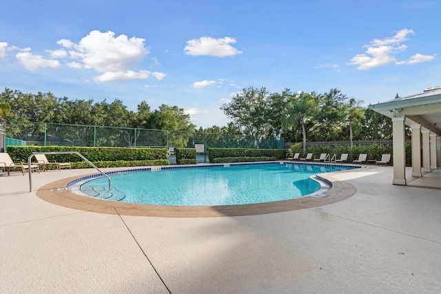 pool featuring a patio and fence