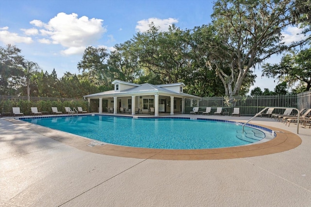 pool featuring a patio area and fence