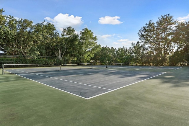 view of sport court featuring fence