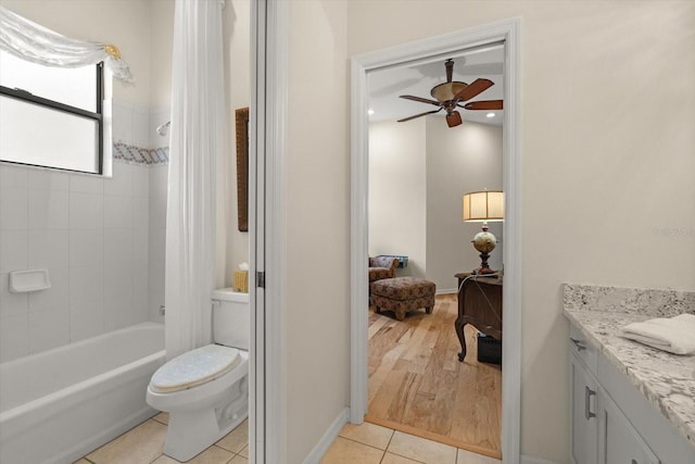 full bathroom featuring tile patterned flooring, ceiling fan, toilet, shower / bath combo, and vanity