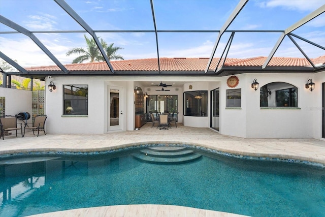 back of property featuring stucco siding, a ceiling fan, a tile roof, an outdoor pool, and a patio area