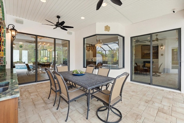 view of patio with outdoor dining area and ceiling fan