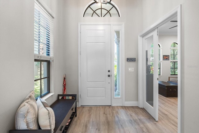 foyer entrance with baseboards and wood finished floors