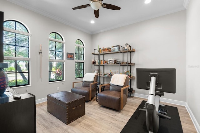 interior space with baseboards, crown molding, and light wood finished floors