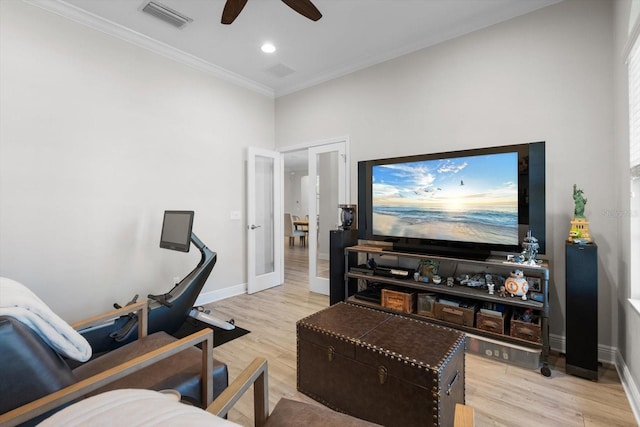 interior space featuring baseboards, visible vents, french doors, crown molding, and light wood-type flooring