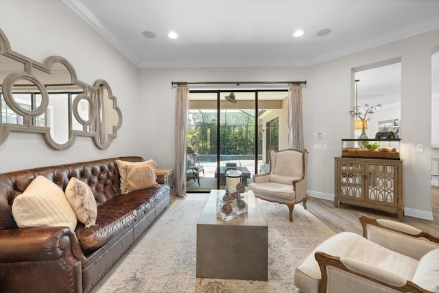 living area featuring wood finished floors, baseboards, recessed lighting, a sunroom, and ornamental molding