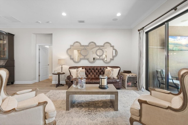 living area with crown molding, wood finished floors, visible vents, and baseboards