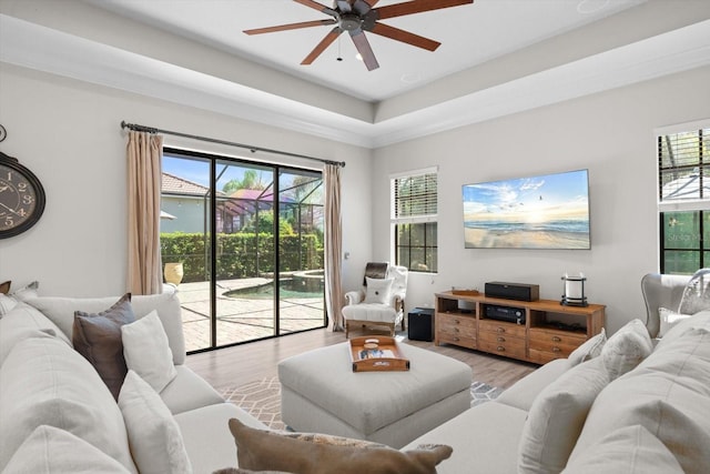 living room featuring a ceiling fan and wood finished floors