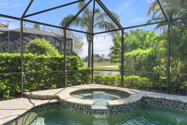 view of pool with a water view, a lanai, and a pool with connected hot tub