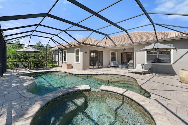 view of swimming pool with a patio area, a lanai, and a pool with connected hot tub