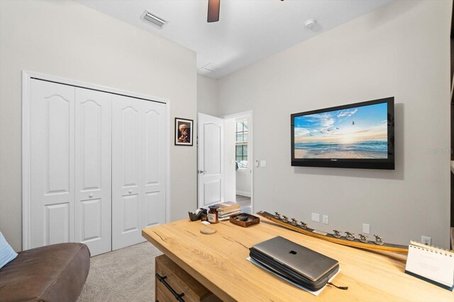 carpeted home office featuring visible vents and a ceiling fan