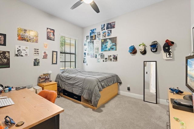 carpeted bedroom with ceiling fan and baseboards