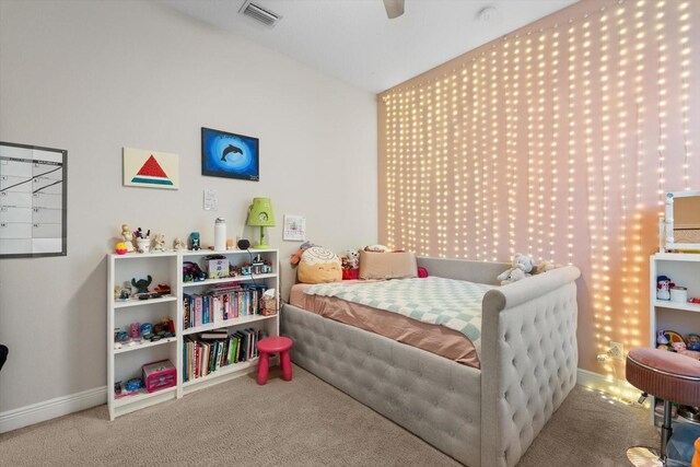 bedroom with visible vents, baseboards, carpet, vaulted ceiling, and a ceiling fan