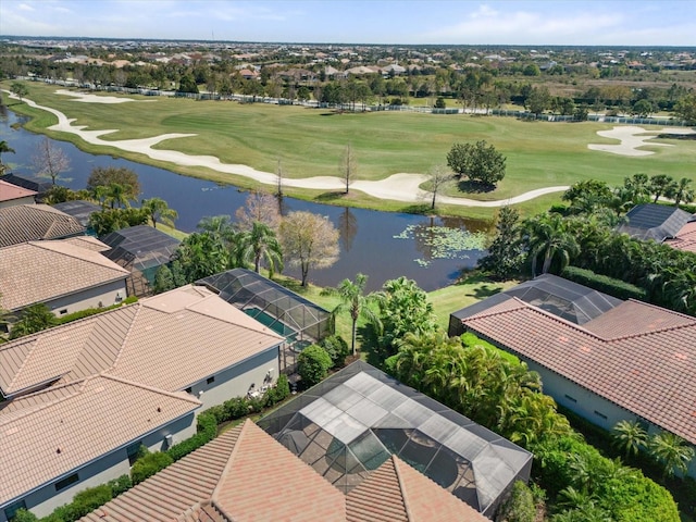 bird's eye view with view of golf course, a water view, and a residential view