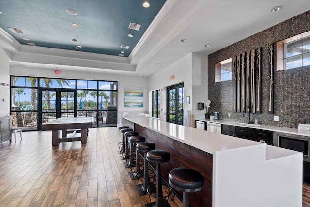 bar featuring visible vents, dishwasher, a wealth of natural light, french doors, and a raised ceiling