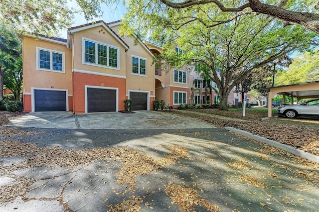 view of front of home featuring stucco siding, driveway, and an attached garage