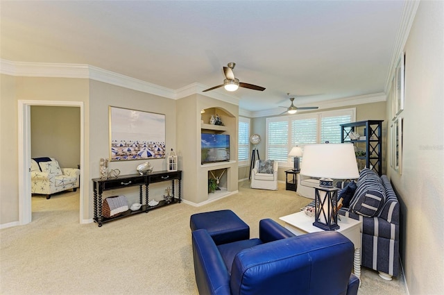 living room with crown molding, carpet flooring, baseboards, and ceiling fan