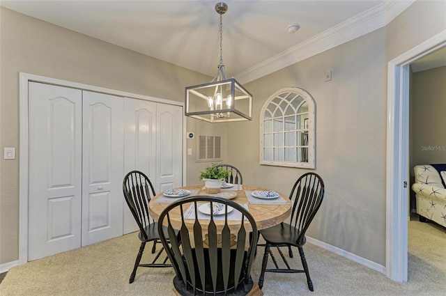 dining space featuring crown molding, carpet flooring, baseboards, and a chandelier