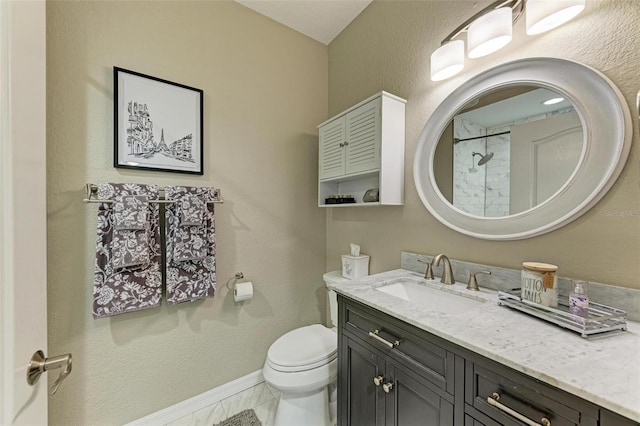 bathroom with baseboards, toilet, walk in shower, and vanity