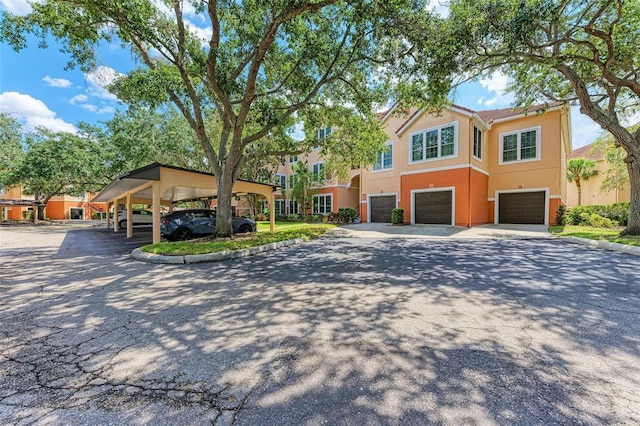 view of front of home with stucco siding, driveway, and an attached garage