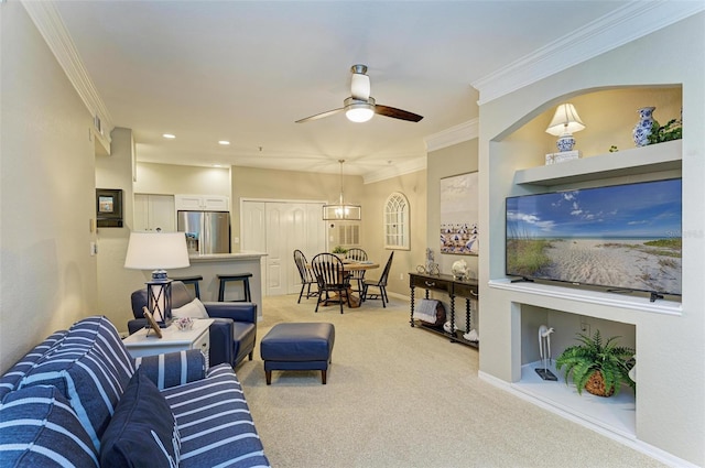 living room featuring a ceiling fan, baseboards, recessed lighting, ornamental molding, and light carpet