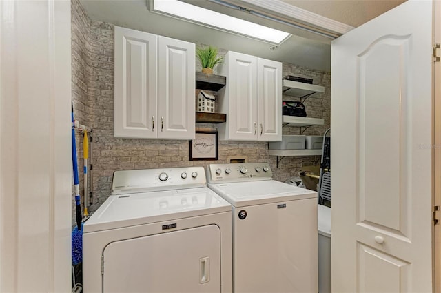 laundry room with cabinet space and separate washer and dryer