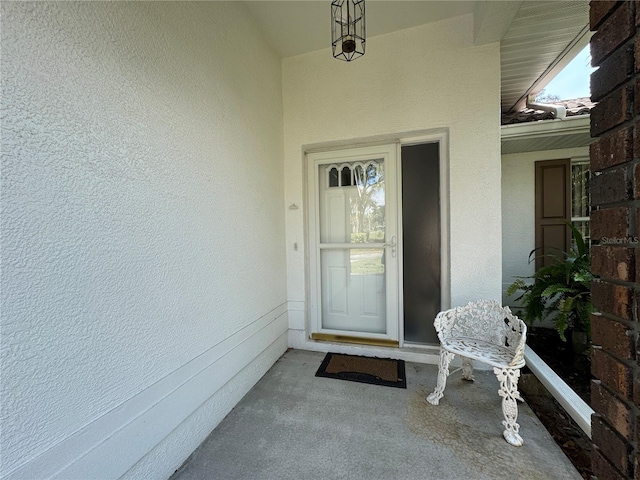 property entrance with stucco siding